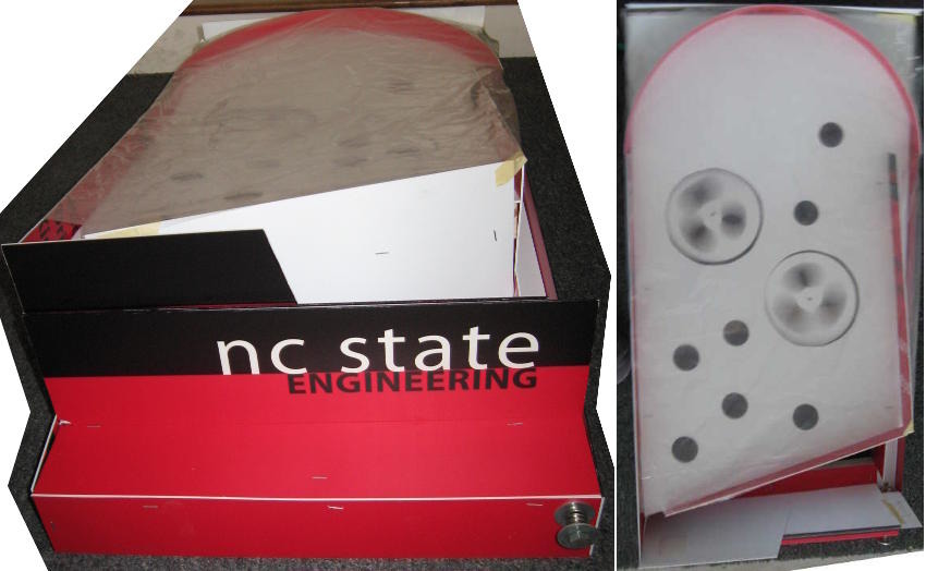 The front view of the arcade game has branding promoting NCSU engineering. The top view of the arcade game shows the holes and spinning disks.